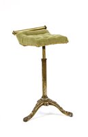 Lot 543 - A Victorian music stool on a cast iron tripod base