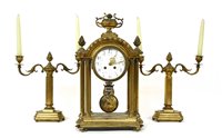 Lot 168 - A late 19th century French brass clock garniture. 47cm high