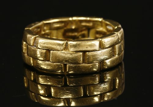 Lot 81 - A gold two row brick link or panther chain effect band ring