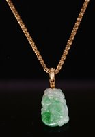 Lot 129 - A Chinese carved jade and diamond gourd pendant