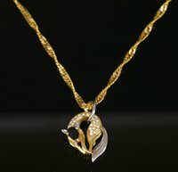 Lot 274 - A gold sapphire and diamond set fox pendant