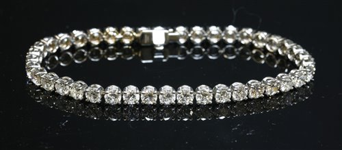 Lot 562 - An 18ct white gold diamond set line bracelet