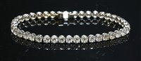 Lot 562 - An 18ct white gold diamond set line bracelet