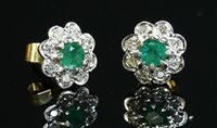 Lot 356 - A pair of gold emerald and diamond daisy cluster earrings