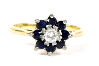 Lot 157 - A diamond and sapphire daisy cluster ring