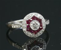 Lot 516 - A platinum, diamond and ruby target style cluster ring