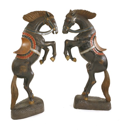 Lot 375 - A pair of large carved wooden and polychrome decorated prancing horses