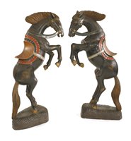 Lot 375 - A pair of large carved wooden and polychrome decorated prancing horses