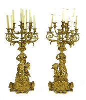 Lot 584 - A pair of gilt bronze ten-light figural candelabra