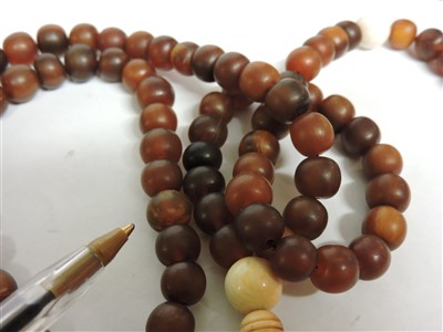Lot 255 - A Chinese rhinoceros horn bead necklace