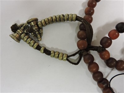 Lot 257 - A Chinese rhinoceros horn bead necklace