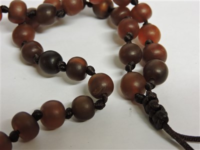 Lot 258 - A Chinese rhinoceros horn bead rosary