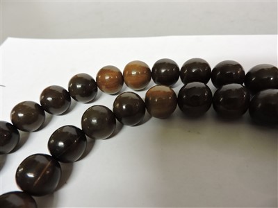 Lot 259 - A Chinese rhinoceros horn bead rosary