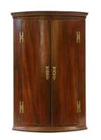 Lot 692 - A mahogany corner cupboard