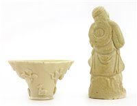 Lot 99 - A Chinese blanc de Chine wine cup and a figure