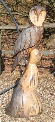 Lot 1112 - A large carved wooden garden sculpture