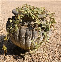 Lot 1086 - A reconstituted stone gadrooned garden urn