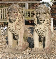 Lot 1109 - A pair of reconstituted stone seated lions on rectangular plinth base