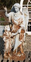 Lot 1118 - A white painted figural group of an angel with a child