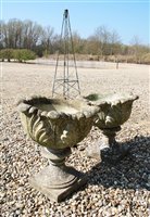 Lot 1119 - A reconstituted stone bird bath of a child in standing pose