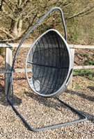 Lot 1111 - A contemporary wicker egg form garden swing chair