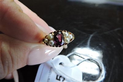 Lot 105 - An Edwardian garnet and pearl boat-shaped ring