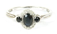 Lot 36 - A white gold sapphire and diamond  cluster ring