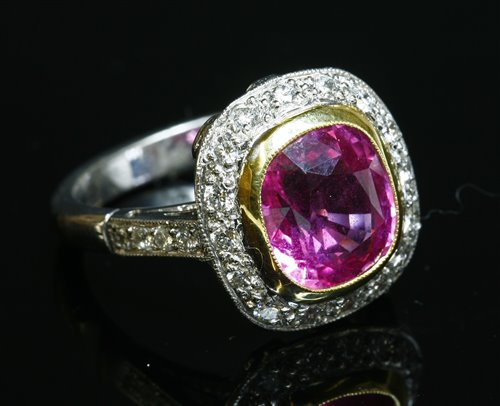 Lot 209 - An 18ct gold pink sapphire and diamond cluster ring