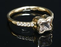Lot 275 - An 18ct rose gold single stone sapphire ring with diamond set shoulders