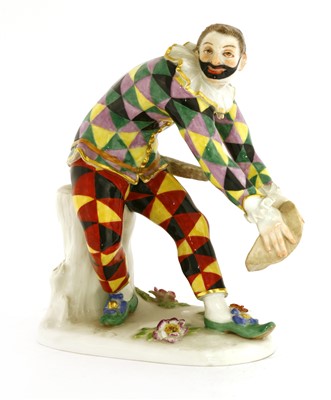 Lot 242 - A Meissen figure of a bowing harlequin