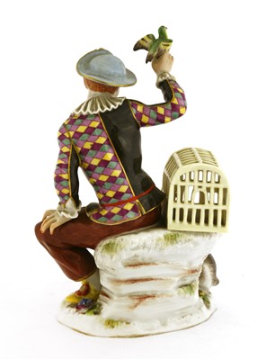 Lot 241 - A Meissen figure of a seated harlequin