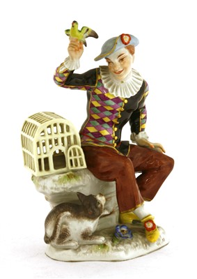 Lot 241 - A Meissen figure of a seated harlequin