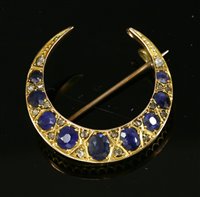Lot 55 - An Edwardian sapphire and diamond closed crescent brooch