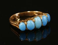 Lot 63 - A five stone turquoise carved head style ring