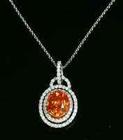 Lot 537 - An 18ct white gold spessartine garnet and diamond two row halo cluster pendant