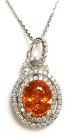 Lot 537 - An 18ct white gold spessartine garnet and diamond two row halo cluster pendant