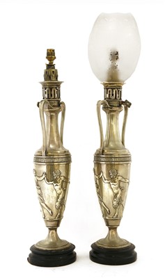 Lot 634 - A pair of silver-plated oil lamps