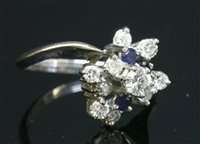 Lot 138 - A Dutch white gold diamond and sapphire crossover cluster ring