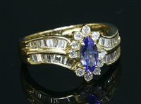 Lot 123 - An American gold tanzanite and diamond crossover cluster ring