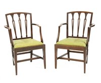 Lot 686 - A pair of hepplewhite mahogany dining chairs with splat backs over open arms, 61 x 45 x 95 cm