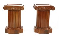 Lot 577 - A pair of low modern column pedestals with cupboards
