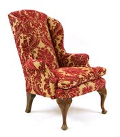 Lot 733 - A Queen Anne style wing back armchair