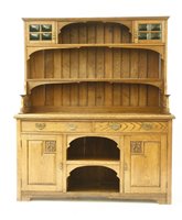 Lot 588 - An Arts & Craft style oak dresser