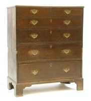 Lot 555 - A George III two part oak chest