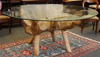 Lot 614 - A modern glass top table on root base, 180 cm...