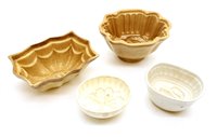 Lot 311 - Thirty pottery jelly moulds, including parrot,...