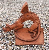 Lot 1084 - A terracotta roof ridge tile surmounted by a dragon, 44 high x 46 deep x 26 wide