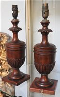 Lot 411 - A pair of carved mahogany urn form table lamps