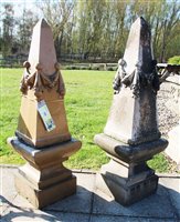 Lot 1007 - A pair of glazed obelisks, each with moulded swags, on plinths, 94 cm high (4)