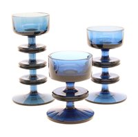 Lot 239 - A set of three blue glass Sheringham candleholders, designed by Ronald Stennett-Wilson for Wedgwood